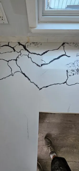 Bold black veining across a white quartz countertop corner