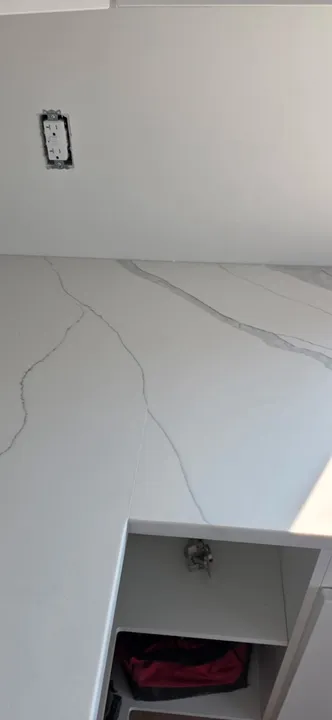 Subtle grey veining along a white quartz countertop seam